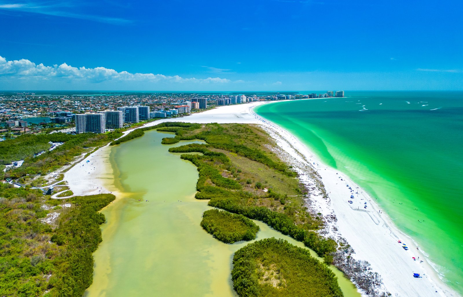 Aerial photograph of Tigertail Beach on Marco Island, showing the tidal lagoon, the mangrove sandbar and the white sand curving along green Gulf water.
